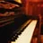A close-up photo of a vintage Blüthner grand piano keyboard with warm lighting.