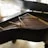 An elegant shot of a Blüthner grand piano in a sunlit room, highlighting its craftsmanship.