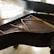 An elegant shot of a Blüthner grand piano in a sunlit room, highlighting its craftsmanship.