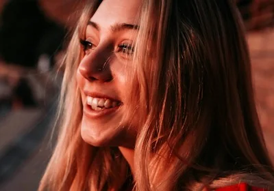 A candid shot of the brand ambassador smiling warmly during a community event, surrounded by fans.